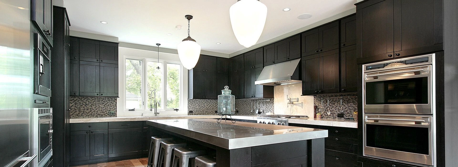 Modern kitchen featuring sleek black cabinetry Modern kitchen featuring sleek black cabinetry